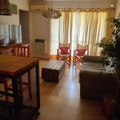 a living room with a couch and a table and chairs at Parques del Chateau in Cordoba