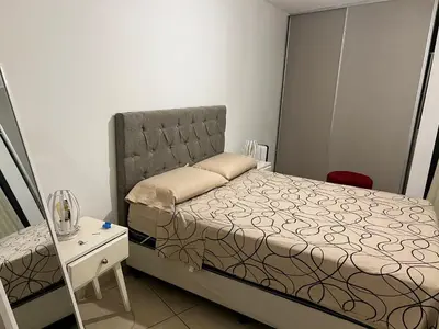 a small bedroom with a bed and a night stand at Mi depto en alta Cba in Cordoba