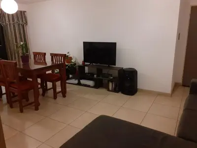 a living room with a table and a television at Mi depto en alta Cba in Cordoba