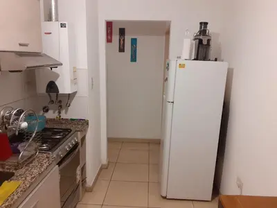 a kitchen with a white refrigerator and a stove at Mi depto en alta Cba in Cordoba