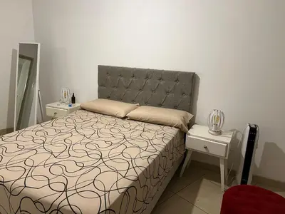 a bedroom with a bed and two night stands at Mi depto en alta Cba in Cordoba