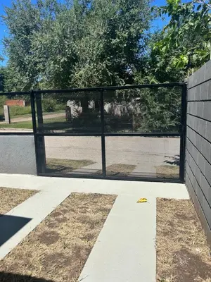 a black fence with a view of a park at La casita de Oli in Tanti