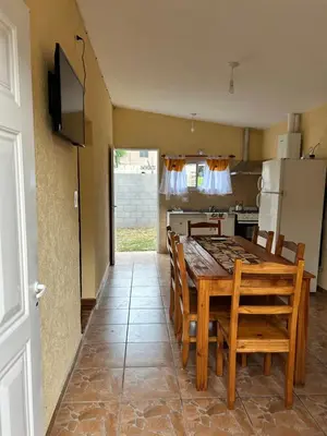 a kitchen and dining room with a table and chairs at La casita de Oli in Tanti
