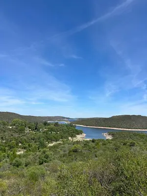 a view of a river in the middle of a field at Refugio de las nubes in Las Rabonas