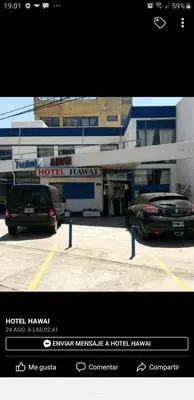 two cars parked in a parking lot in front of a hotel at Hotel Hawai in Villa Carlos Paz
