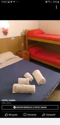 a bedroom with a bed with two towels on it at Hotel Hawai in Villa Carlos Paz