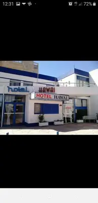 a building with a hotel hazard sign in front of it at Hotel Hawai in Villa Carlos Paz
