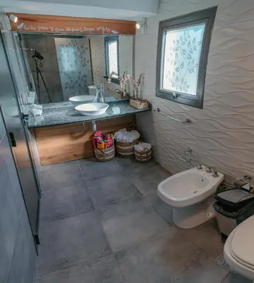 a bathroom with a sink and a toilet at Cabañas Las Marias - Mirador del Lago in Villa Parque Siquiman
