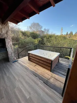 a bath tub sitting on a wooden deck at Cabañas Las Marias - Mirador del Lago in Villa Parque Siquiman