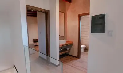 a bathroom with a mirror and a sink and a toilet at Cabañas Las Marias - Mirador del Lago in Villa Parque Siquiman