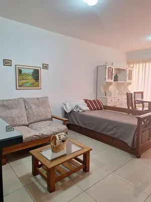a living room with a bed and a couch at La Plata in Villa Carlos Paz