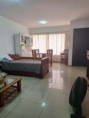 a bedroom with a bed and a table and chairs at La Plata in Villa Carlos Paz
