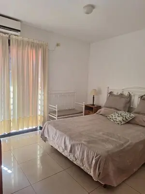 a bedroom with a large bed and a window at La Plata in Villa Carlos Paz
