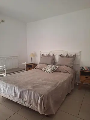 a bedroom with a large bed with two pillows at La Plata in Villa Carlos Paz