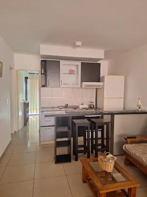 a kitchen with a counter and a table in a room at La Plata in Villa Carlos Paz