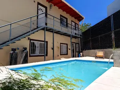 a swimming pool in the backyard of a house at Complejo Gabriel - Departamentos Temporarios in Villa Carlos Paz