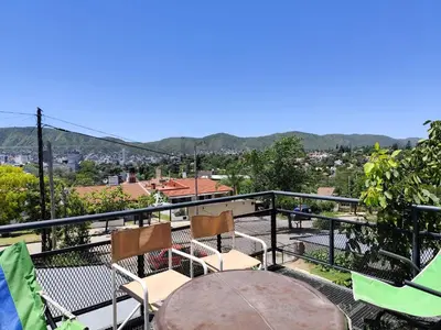 a table and chairs on a balcony with a view at Complejo Gabriel - Departamentos Temporarios in Villa Carlos Paz
