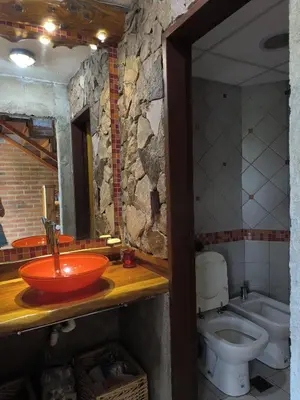 a bathroom with a sink and a toilet at Casa montaña & jacuzzi in Embalse