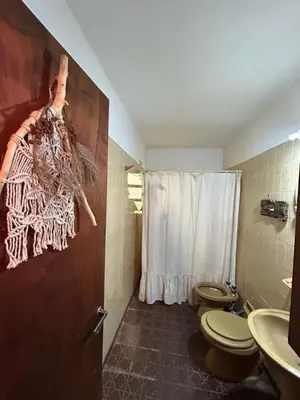 a bathroom with two toilets and a shower at Casa Jazmín in Villa Carlos Paz