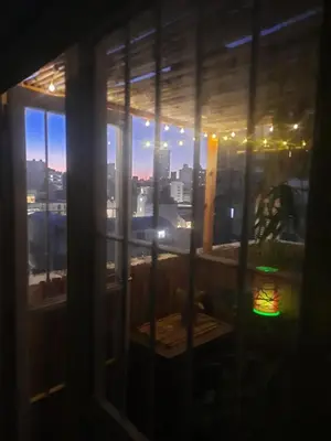 a window with a view of a city at night at Derpa Zion in Cordoba