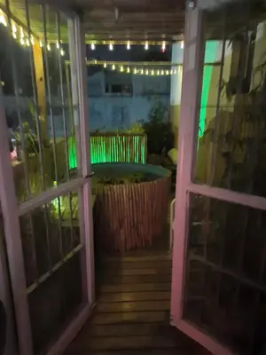 an open door to a patio with a plant at Derpa Zion in Cordoba