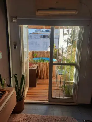 an open door to a deck with a view at Derpa Zion in Cordoba
