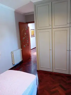 a bedroom with a white bed and a closet at CASA RIO TERCERO Cordoba Argentina in Río Tercero