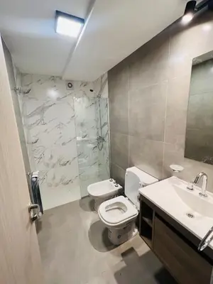 a bathroom with a toilet and a sink and a shower at Duplex temporario en Villa Carlos Paz in Villa Carlos Paz