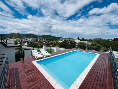 a swimming pool on the roof of a house at Duplex temporario en Villa Carlos Paz in Villa Carlos Paz