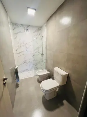 a bathroom with a toilet and a sink at Duplex temporario en Villa Carlos Paz in Villa Carlos Paz