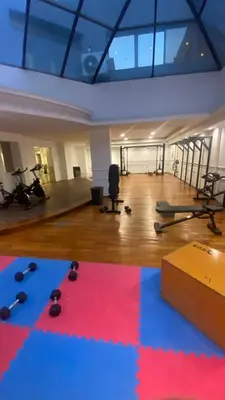 a gym with dumbbells and exercise equipment in a room at Apartamento con piscina en pleno centro de cordoba in Cordoba