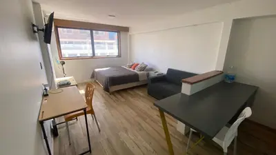 a small living room with a couch and a table at Apartamento con piscina en pleno centro de cordoba in Cordoba