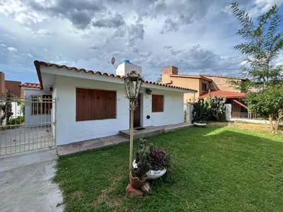 a small white house with a grass yard at Casa Jazmin in La Cuesta