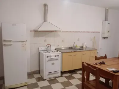 a kitchen with a white stove and a sink at El Quebrachito in Alta Gracia