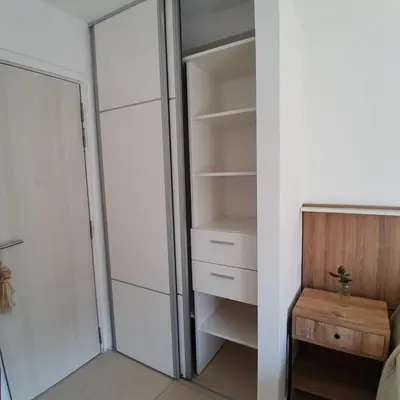 a walk in closet with a wooden table and a door at Departamento temporal in Cordoba