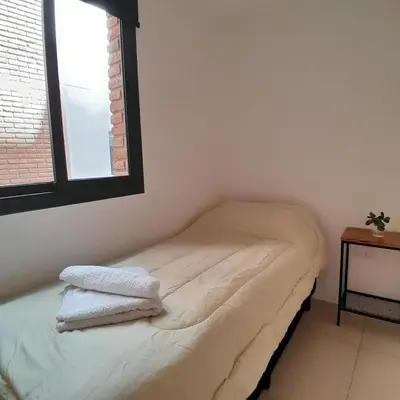 a room with a bed with two towels on it at Departamento temporal in Cordoba