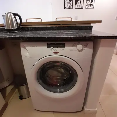 a washing machine with a counter on top of it at Departamento temporal in Cordoba