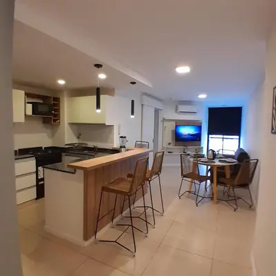 a kitchen and dining room with a table and chairs at Departamento temporal in Cordoba