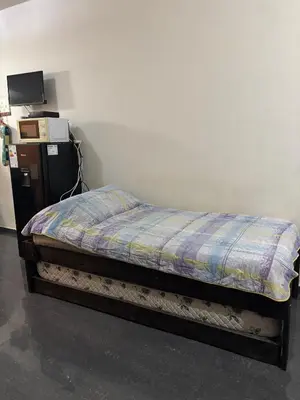 a bed in a room with a tv on a wall at Dpto monoambiente in Villa Carlos Paz