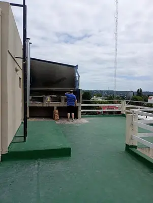 a man standing on the roof of a building at Dpto monoambiente in Villa Carlos Paz
