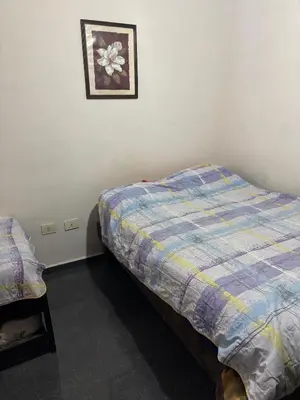 a bedroom with a bed and a picture on the wall at Dpto monoambiente in Villa Carlos Paz