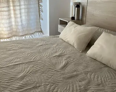 an unmade bed with pillows and a blanket at Depto en Güemes in Cordoba