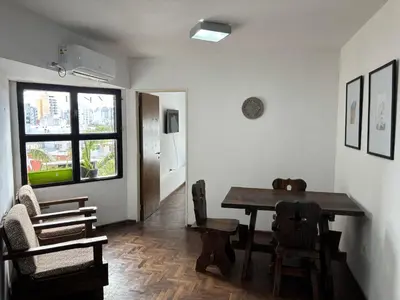 a dining room with a wooden table and chairs at Depto en Güemes in Cordoba