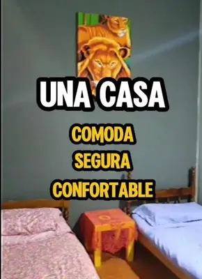 a room with two beds and a sign that reads una casa comoria at Chalet LA BERNI in Villa Carlos Paz