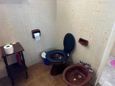 a bathroom with a toilet and a sink at Chalet LA BERNI in Villa Carlos Paz
