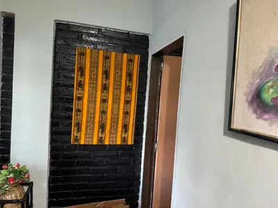 a room with a door with yellow sticks on it at Chalet LA BERNI in Villa Carlos Paz