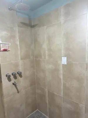 a shower with a large tiled shower at Chalet LA BERNI in Villa Carlos Paz