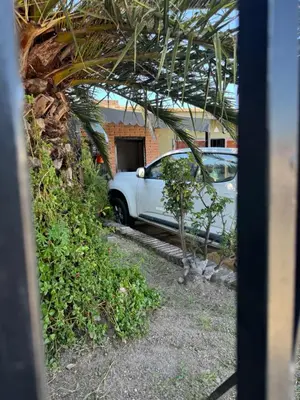 a white car parked in front of a house at Chalet LA BERNI in Villa Carlos Paz