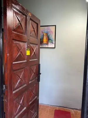 a door in a room with a jug on the wall at Chalet LA BERNI in Villa Carlos Paz