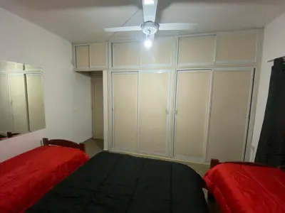 a bedroom with two beds and a ceiling fan at Casa La Paz in Villa Carlos Paz